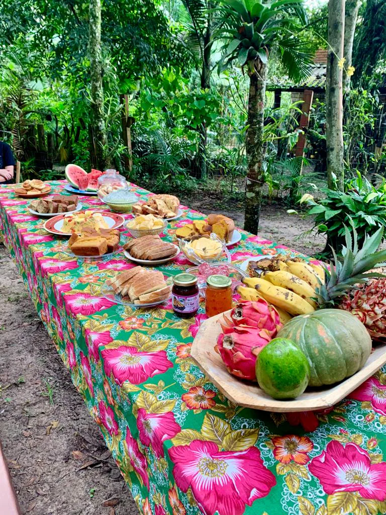 Mesa ao ar livre com frutas e alimentos no Sítio Menezes