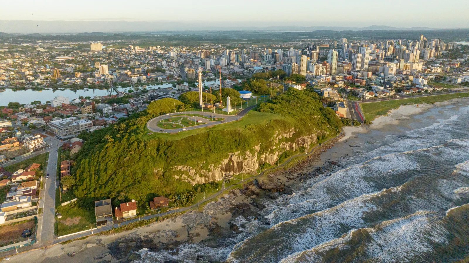 Vista aérea del Morro do Farol, con acantilados, costa y ciudad al fondo